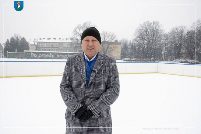 Prezydent Ludomir Handzel na tle lodowiska.